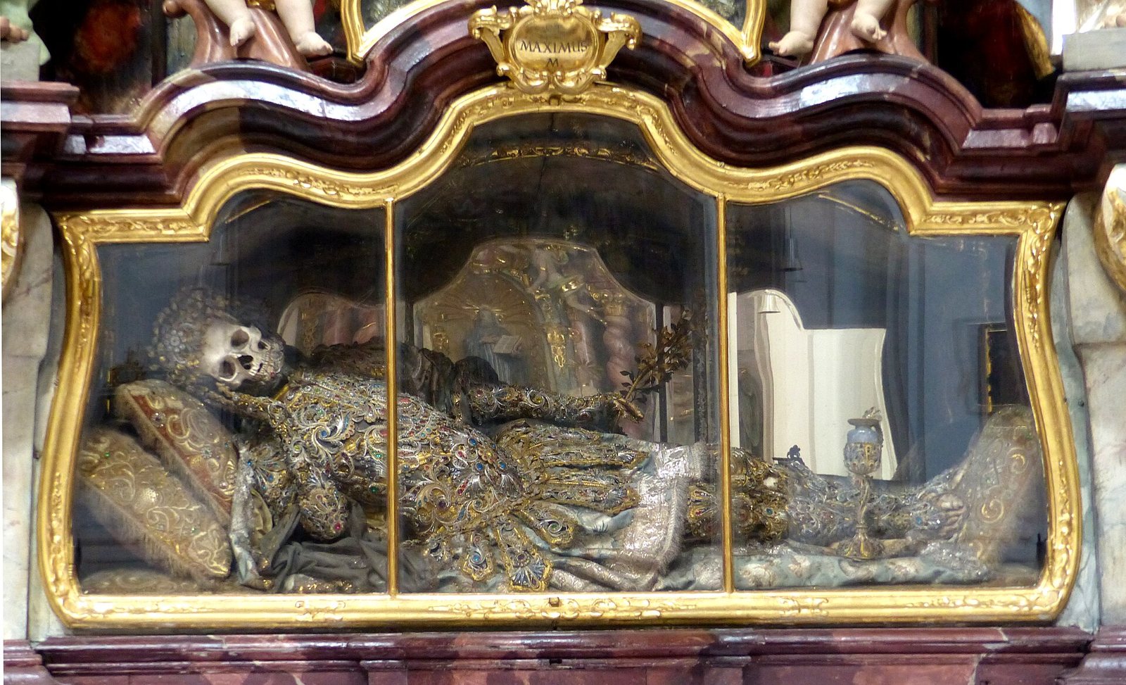The catacomb saint Maximinus lying on cushions in a gilded glass shrine at Waldsassen Basilica, the skeleton dressed in embroidered silver and gold finery