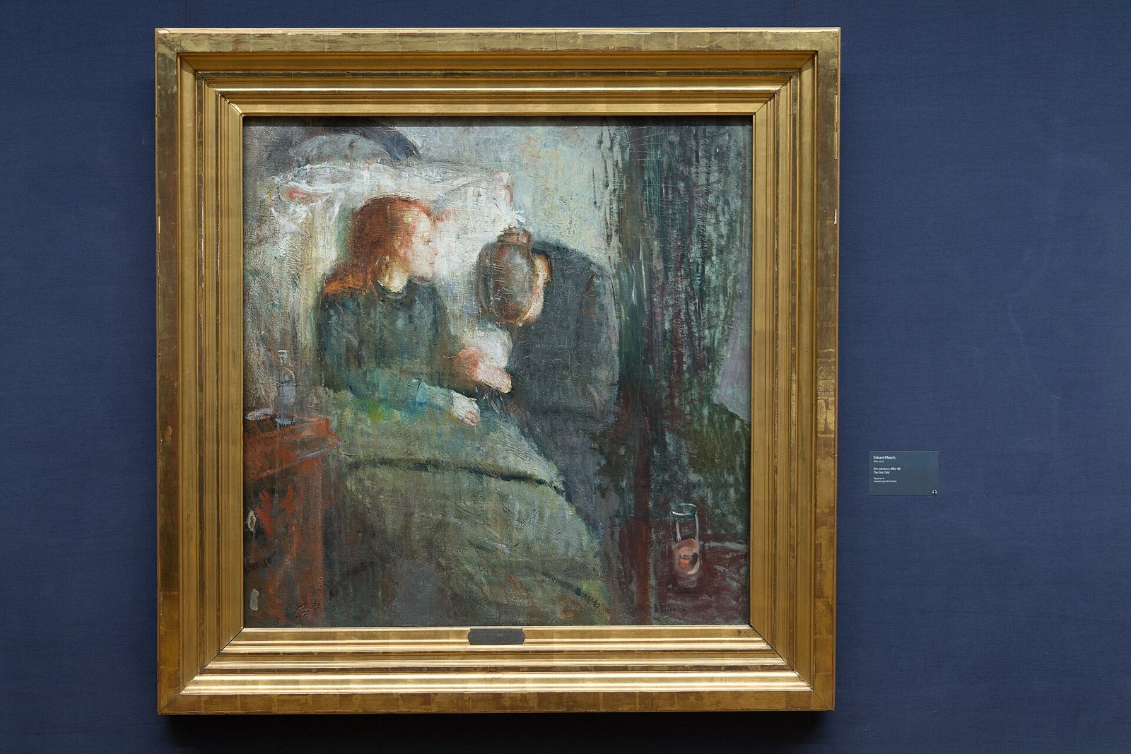 Edvard Munch's painting in its gold frame: a pale red-haired girl propped on a pillow in bed, with a grieving woman bowed beside her