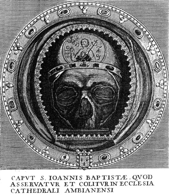 A black-and-white engraving of a round reliquary showing a skull face under a crown-like band, with a Latin caption naming the head of John the Baptist at Amiens Cathedral