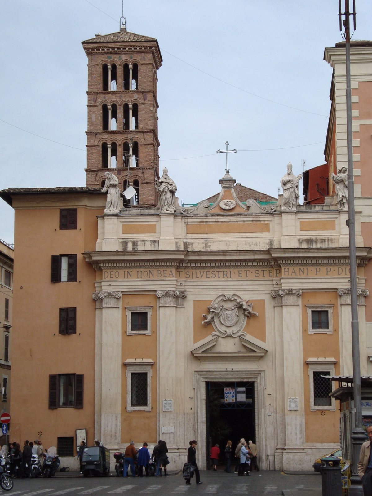 The pale baroque facade of San Silvestro in Capite in Rome, with its brick bell tower rising behind it