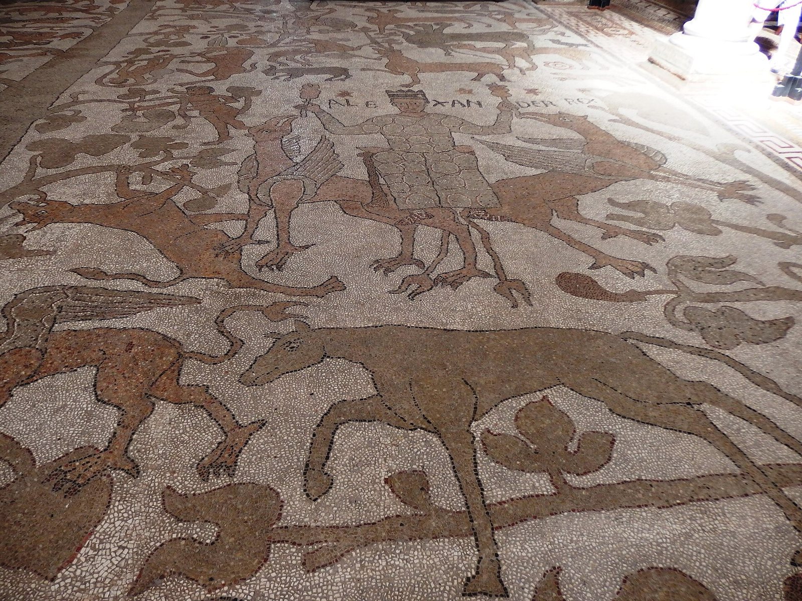 A section of the cathedral floor mosaic in Otranto, with figures of people and animals picked out in dark and pale stone pieces