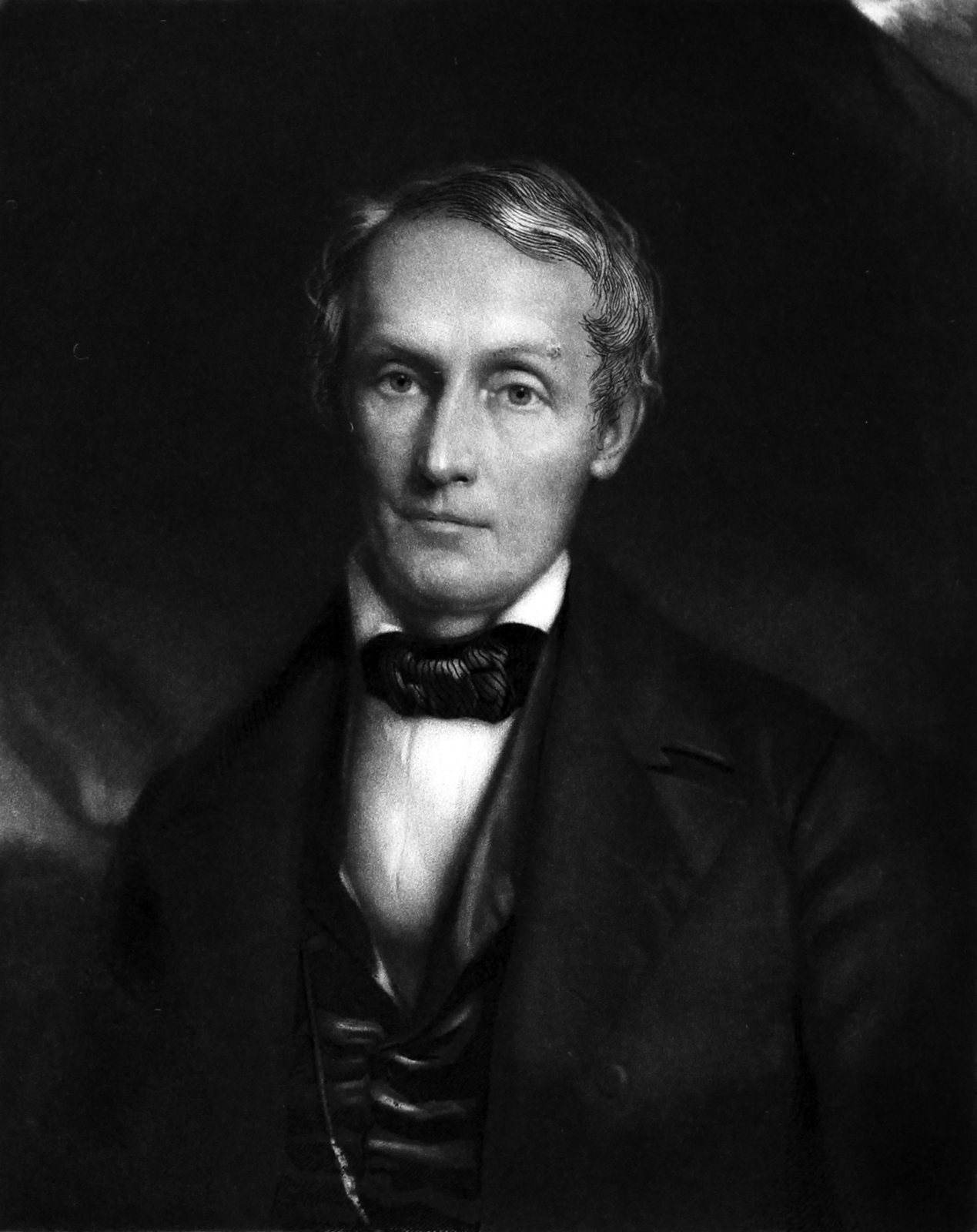 Retrato en blanco y negro de Samuel George Morton, un hombre mayor de cabello peinado hacia atrás, con abrigo oscuro, chaleco y pajarita, que mira hacia quien observa
