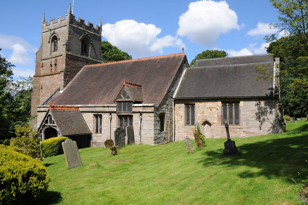 St Leonard's Church at Beoley, a small stone church with a square tower and a churchyard of gravestones on a green lawn