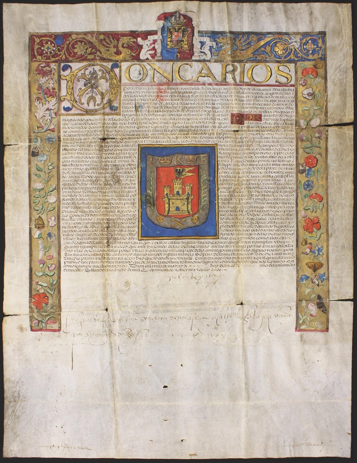 A handwritten royal decree on parchment with an illuminated floral border and the painted arms of Tlaxcala, a castle on a red field, at its center