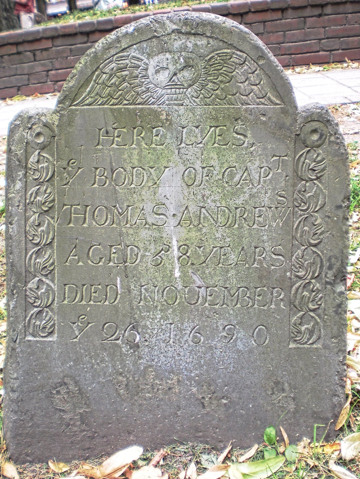 Slate gravestone of Captain Thomas Andrews, died November 26, 1690, with spread wings carved in the arch above the lettering and leafy borders down each side