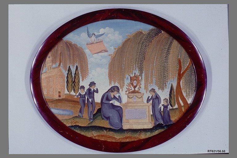 An oval embroidered mourning picture: a woman weeps against a monument topped by an urn, with two men and a girl beside it, weeping willows behind and an angel in the sky